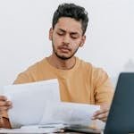 Man looking through documents at workplace