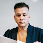 Photo Of Man Reviewing Paperworks